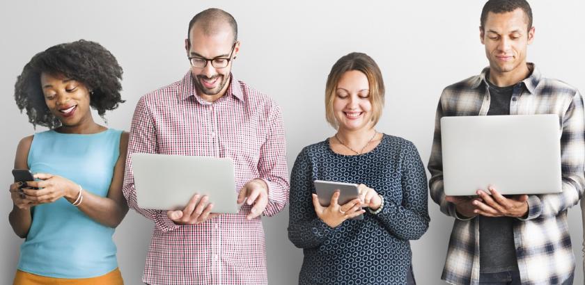 Four people studying on laptops, tablets and phones